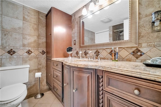 6722 Silvermound Dr, Mentor, OH 44060 - bathroom featuring tile patterned flooring, tile walls, toilet, vanity, and decorative backsplash