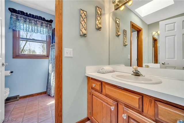6722 Silvermound Dr, Mentor, OH 44060 - full bath with a skylight, toilet, vanity, tile patterned flooring, and baseboards