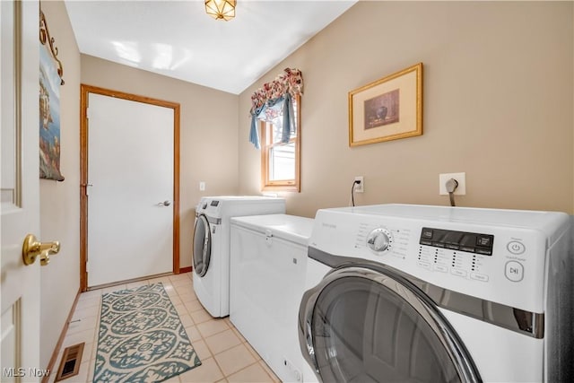 6722 Silvermound Dr, Mentor, OH 44060 - clothes washing area with washer and dryer and light tile patterned flooring