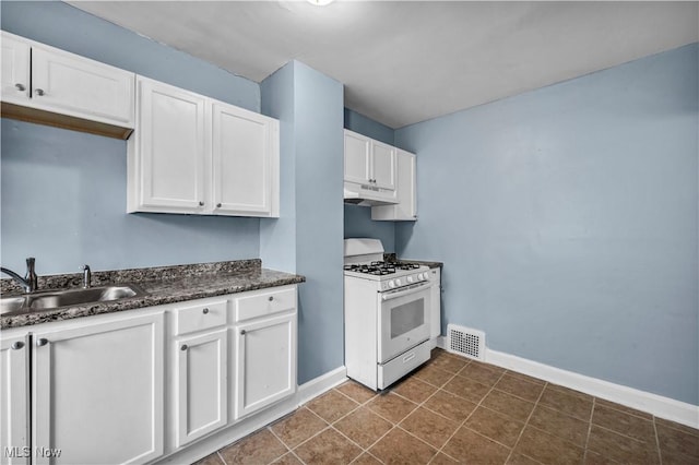 kitchen featuring gas range gas stove, under cabinet range hood, a sink, visible vents, and white cabinets