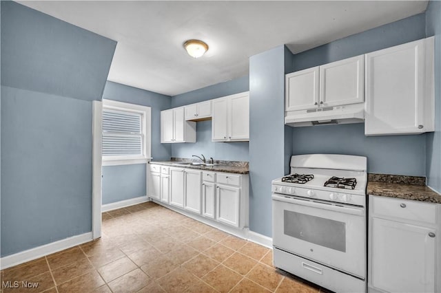 kitchen with white cabinets, baseboards, white range with gas cooktop, under cabinet range hood, and a sink