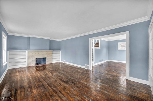 unfurnished living room featuring ornamental molding, baseboards, hardwood / wood-style flooring, visible vents, and a brick fireplace