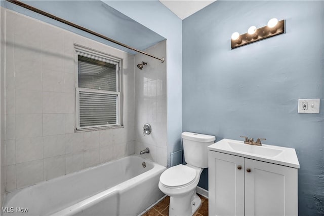 bathroom featuring toilet, vanity, and bathing tub / shower combination
