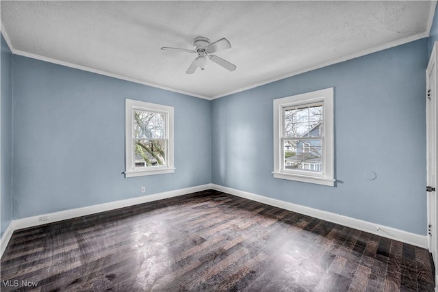 empty room with wood finished floors, crown molding, baseboards, and ceiling fan