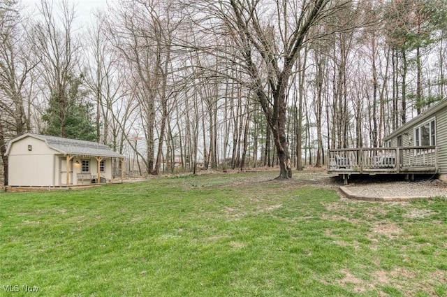 view of yard with an outdoor structure and a deck