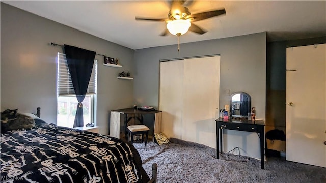 carpeted bedroom featuring ceiling fan and a closet