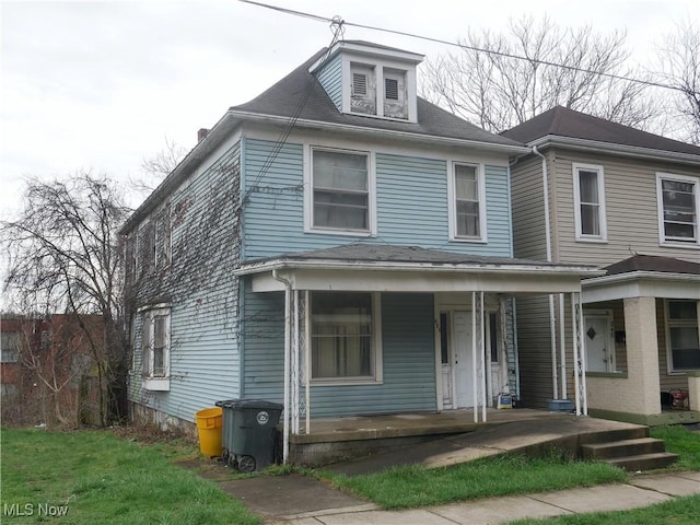 american foursquare style home with a porch