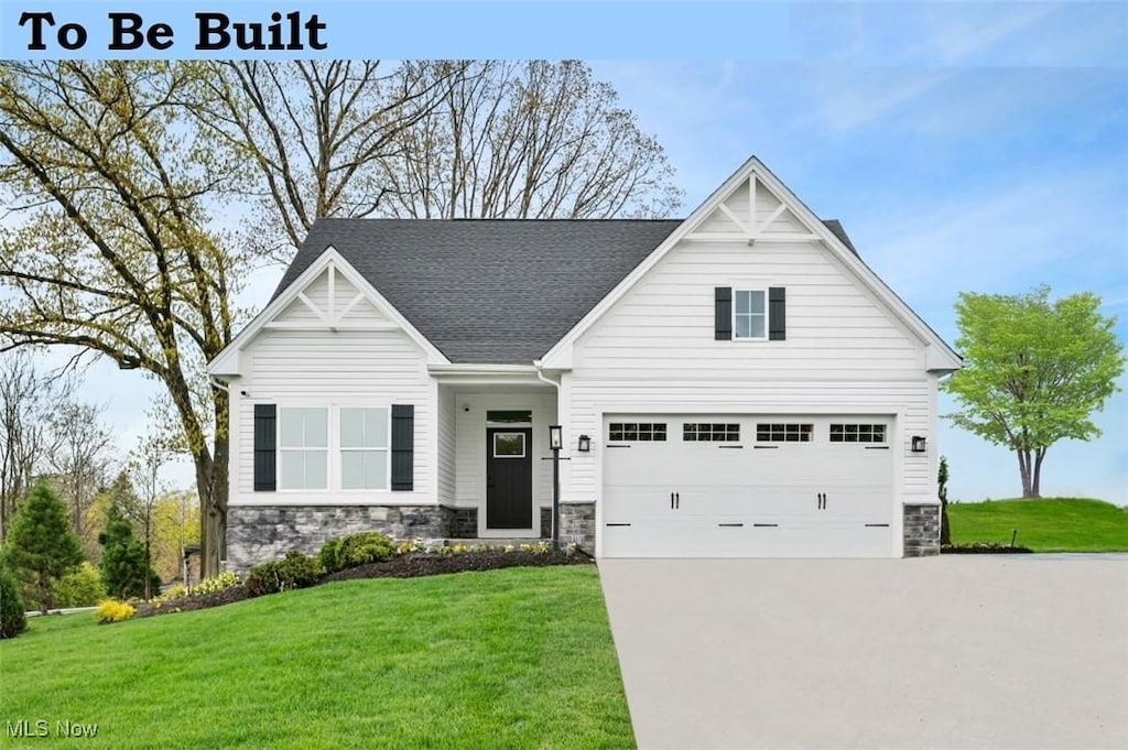 S/L213 Woodsong Dr, Middlefield, OH 44062 - view of front facade with stone siding, concrete driveway, an attached garage, a front lawn, and a shingled roof