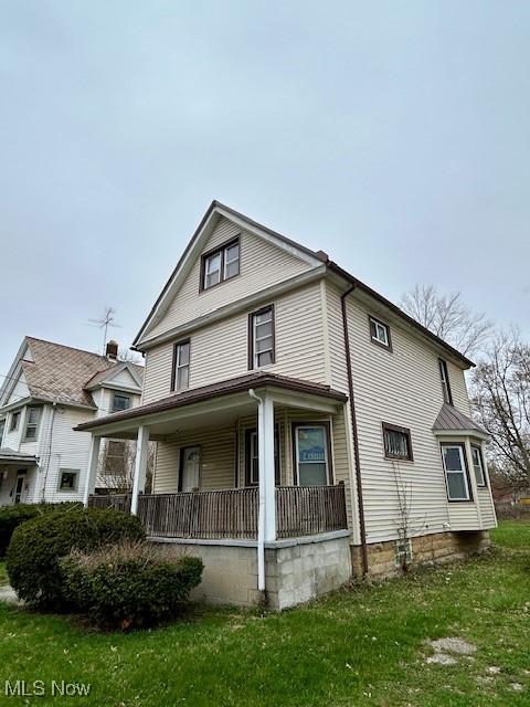 119 Erie St, Elyria, OH 44035 - view of front of house featuring a porch and a front yard