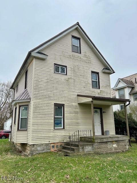 119 Erie St, Elyria, OH 44035 - rear view of house with a yard