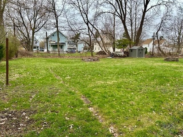 119 Erie St, Elyria, OH 44035 - view of yard featuring an outbuilding and a storage shed