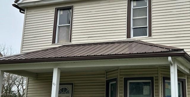 119 Erie St, Elyria, OH 44035 - view of property exterior featuring metal roof