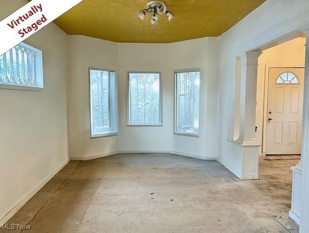 119 Erie St, Elyria, OH 44035 - foyer with a wealth of natural light, baseboards, and ornate columns
