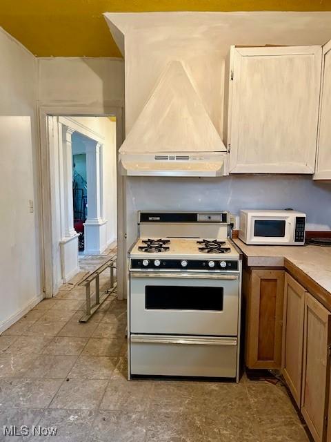 119 Erie St, Elyria, OH 44035 - kitchen with light countertops, custom range hood, and white appliances
