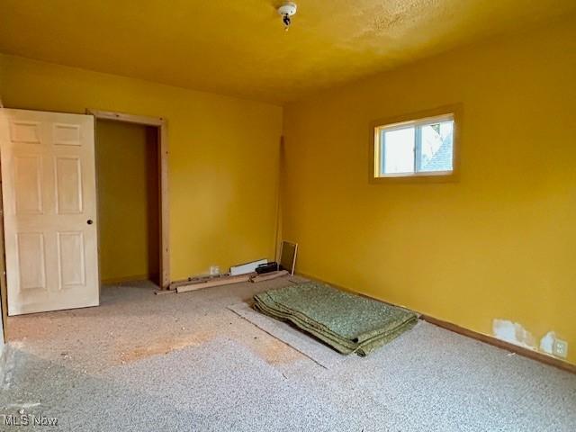 119 Erie St, Elyria, OH 44035 - unfurnished bedroom with baseboards and carpet flooring