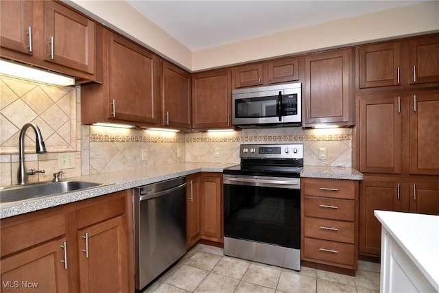 3333 Warrensville Center Rd Unit 204, Shaker Heights, OH 44122 - kitchen with decorative backsplash, light countertops, a sink, and stainless steel appliances