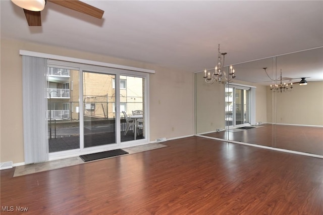 3333 Warrensville Center Rd Unit 204, Shaker Heights, OH 44122 - empty room featuring baseboards, visible vents, wood finished floors, and ceiling fan with notable chandelier