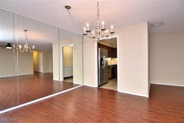 3333 Warrensville Center Rd Unit 204, Shaker Heights, OH 44122 - unfurnished dining area featuring baseboards, wood finished floors, and a chandelier