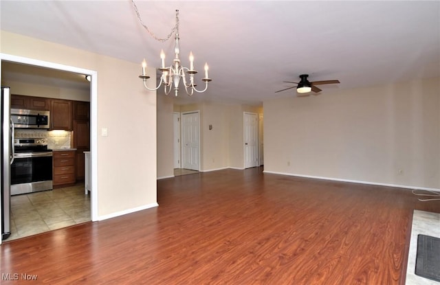 3333 Warrensville Center Rd Unit 204, Shaker Heights, OH 44122 - unfurnished living room with ceiling fan with notable chandelier, light wood-style floors, and baseboards