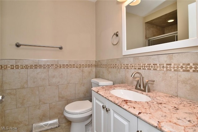 3333 Warrensville Center Rd Unit 204, Shaker Heights, OH 44122 - bathroom with toilet, vanity, a shower stall, visible vents, and tile walls