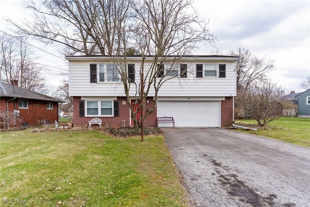 view of front of home with a garage, a front yard, aphalt driveway, and brick siding