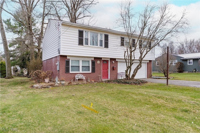 colonial house with brick siding, an attached garage, a front lawn, and aphalt driveway