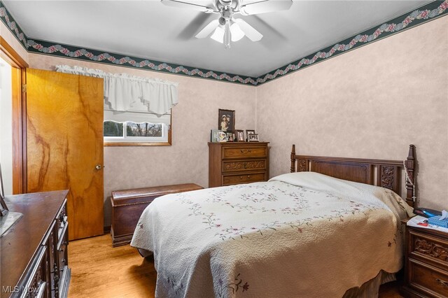 bedroom with ceiling fan and light wood-style flooring