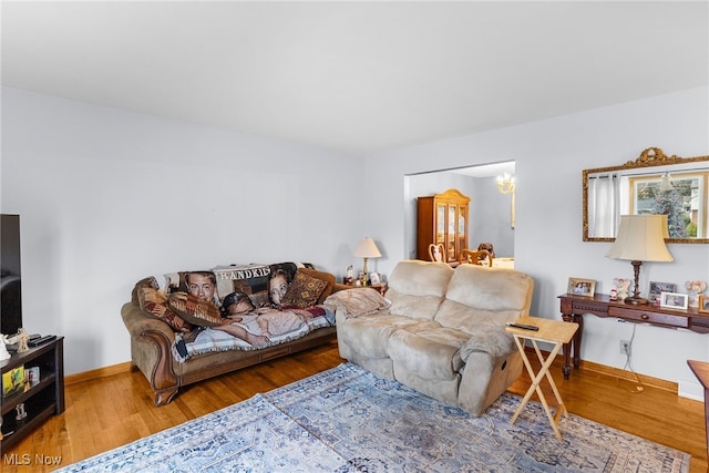 living area featuring baseboards and wood finished floors