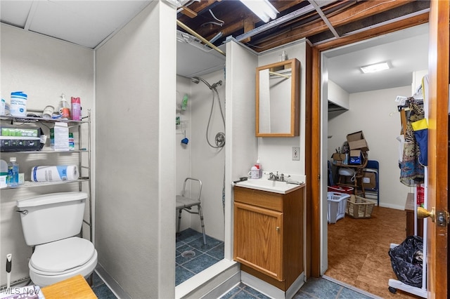bathroom with vanity, a shower, and toilet