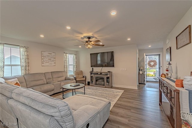 living room with recessed lighting, ceiling fan, baseboards, and wood finished floors