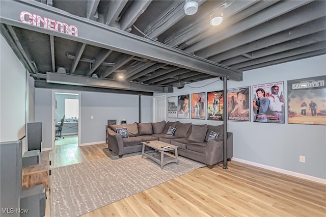 living area with baseboards and wood finished floors