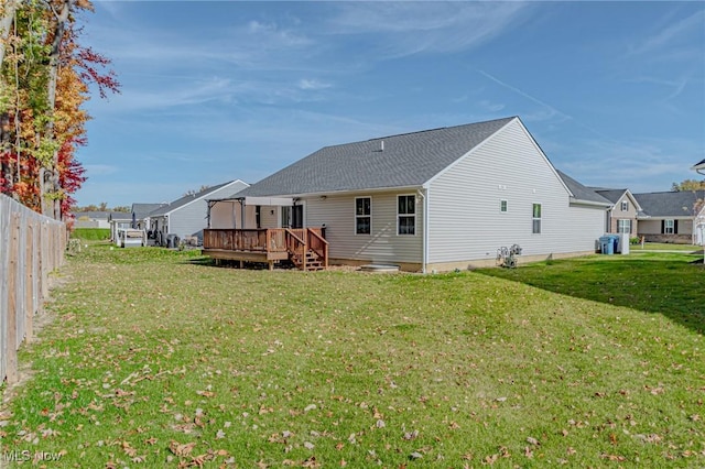 back of house featuring a yard, fence, a deck, and central AC