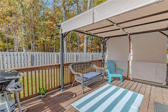 deck with area for grilling and fence