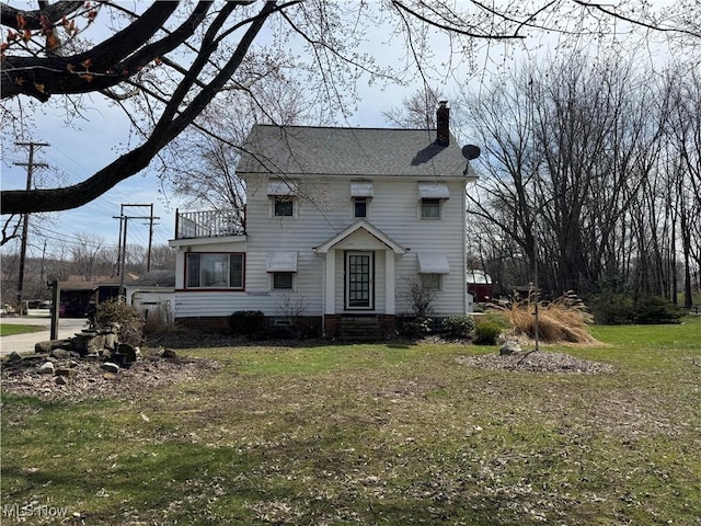 9590 Lake Shore Blvd, Mentor, OH 44060 - view of front of property featuring entry steps, a chimney, roof with shingles, and a front lawn