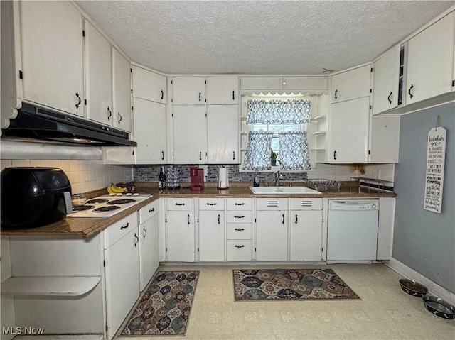 kitchen featuring white appliances, light floors, open shelves, under cabinet range hood, and a sink