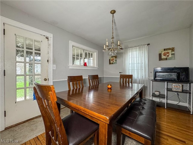 dining room with an inviting chandelier and wood finished floors