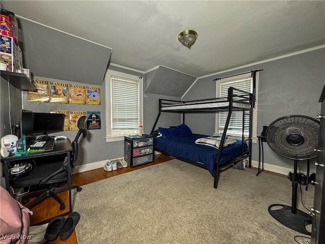 bedroom featuring vaulted ceiling, baseboards, and ornamental molding
