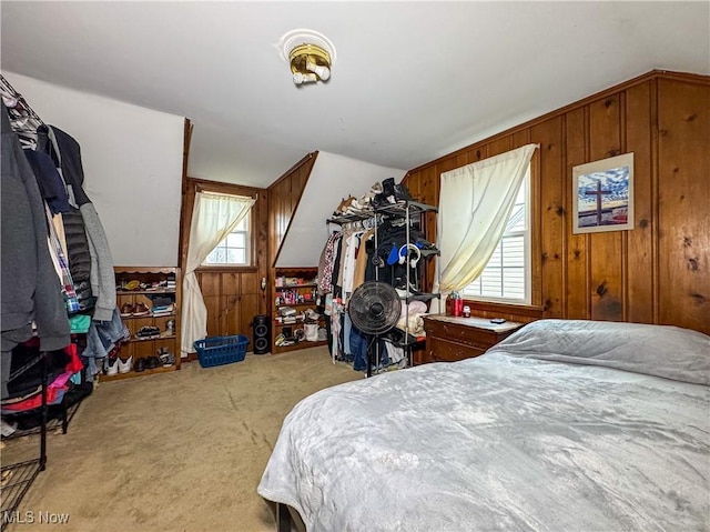 carpeted bedroom with wooden walls