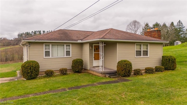 54260 Bracken Rd, Bridgeport, OH 43912 - view of front of home with a chimney, a shingled roof, and a front lawn