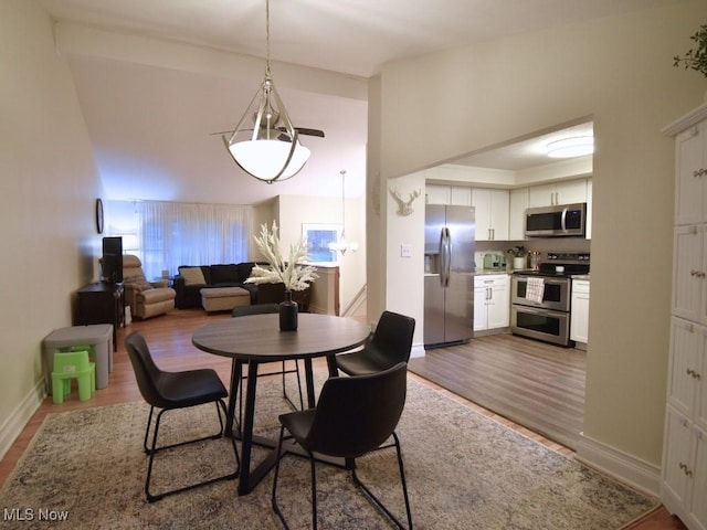 dining area featuring baseboards and wood finished floors