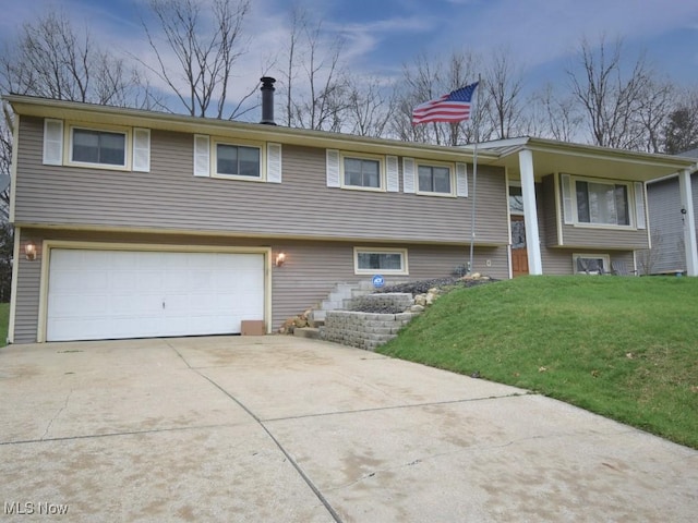 view of front of house with a garage, a front yard, and concrete driveway