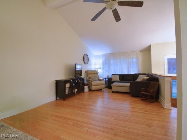 living area featuring high vaulted ceiling, light wood-style floors, baseboards, and ceiling fan