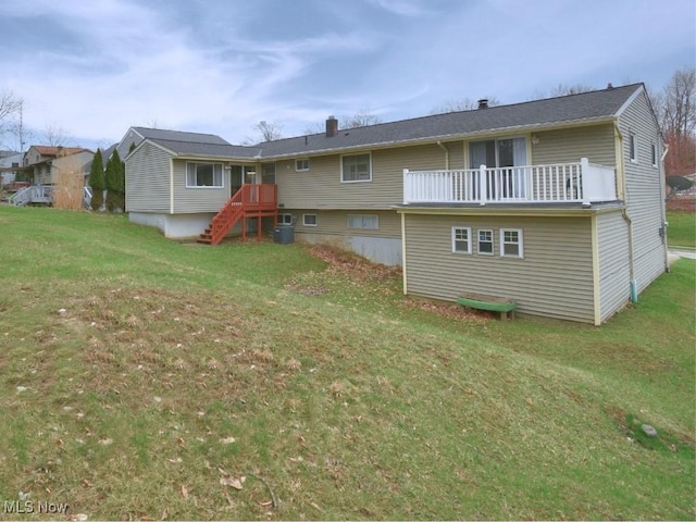 back of house with a balcony and a lawn