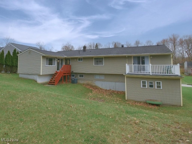 rear view of property with cooling unit and a yard