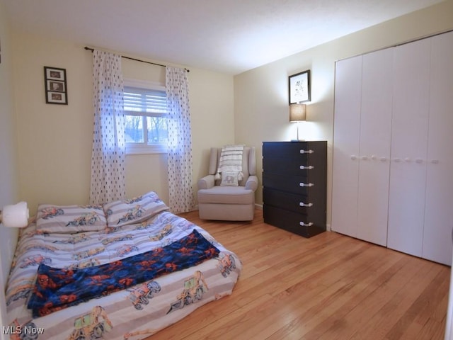 bedroom with light wood finished floors