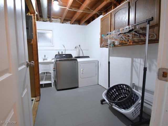 washroom featuring a sink, independent washer and dryer, and laundry area