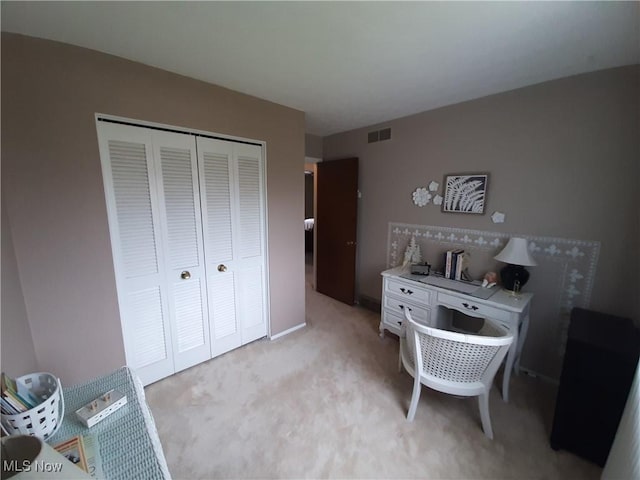office area featuring visible vents and light carpet