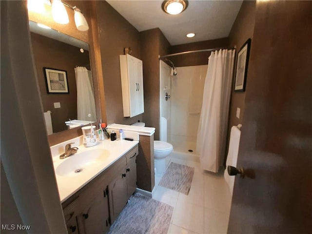 full bath with tile patterned flooring, toilet, a stall shower, and vanity