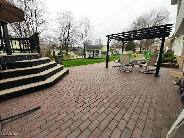 view of patio / terrace featuring an outbuilding, a pergola, and outdoor dining space