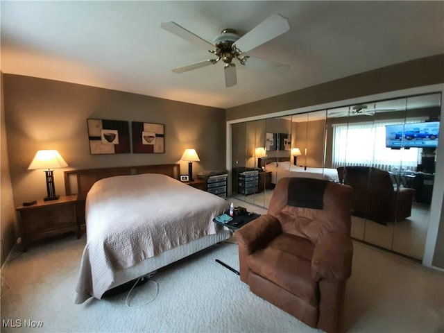bedroom featuring light colored carpet and a ceiling fan